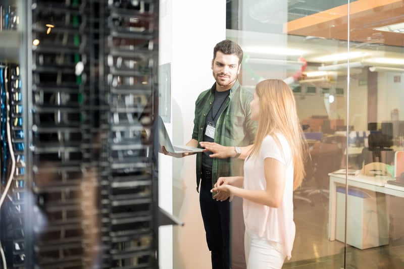 2 people looking over the data center