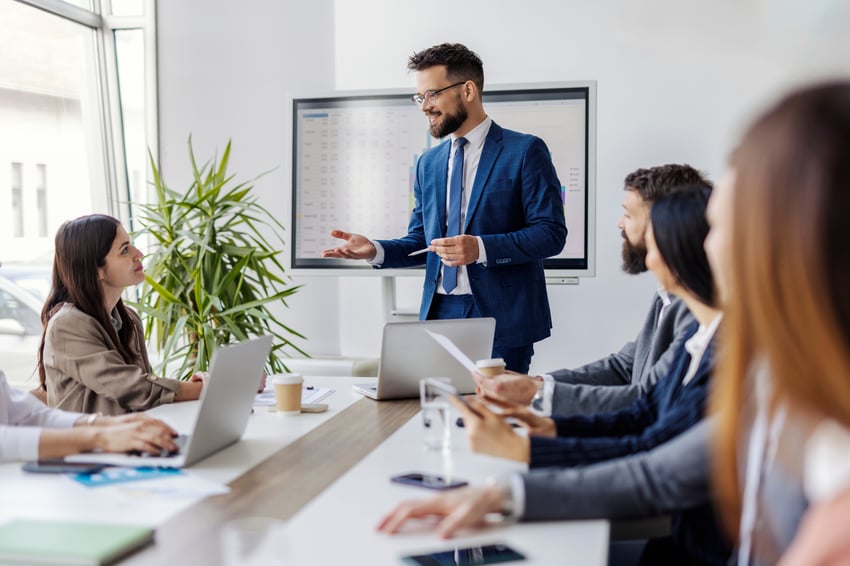 Man speaking to his team in a conference room