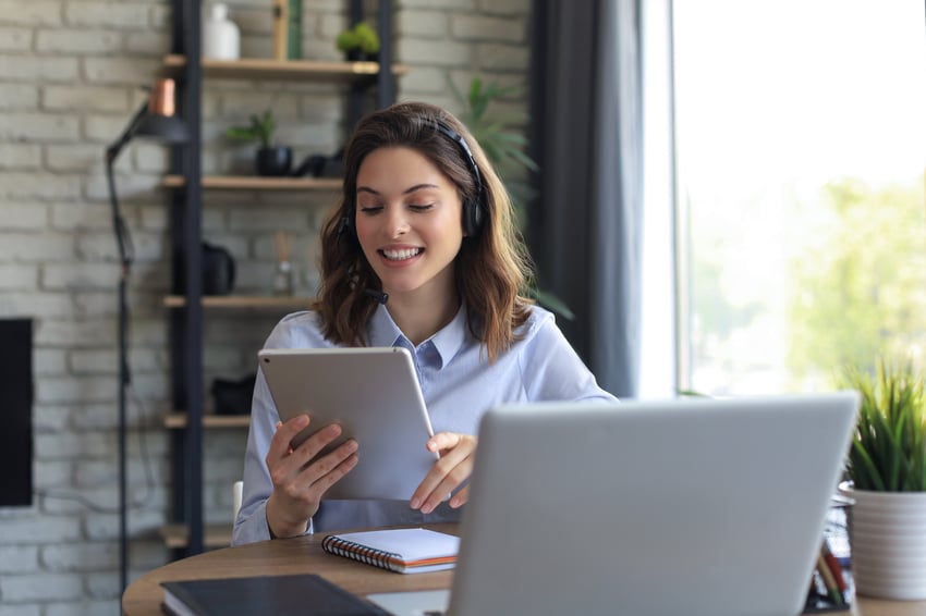 Women on headset looking at a ipad