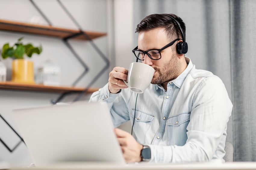Man taking a team meeting from home