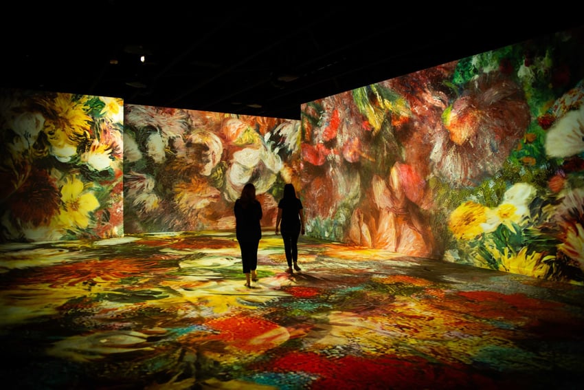 People walking through floral immersive experience 